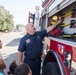 Firefighter presents fire equipment and tools to kids