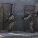 Marines blow the door off its hinges