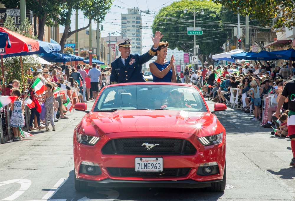 Coast Guard Vice Adm. Charles Ray waves to the crowd during during the Italian Heritage Parade