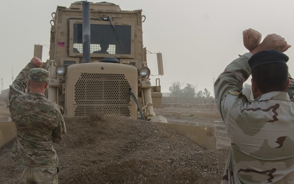 US Soldiers provide Iraqi soldiers bulldozer training to build defenses, clear obstacles