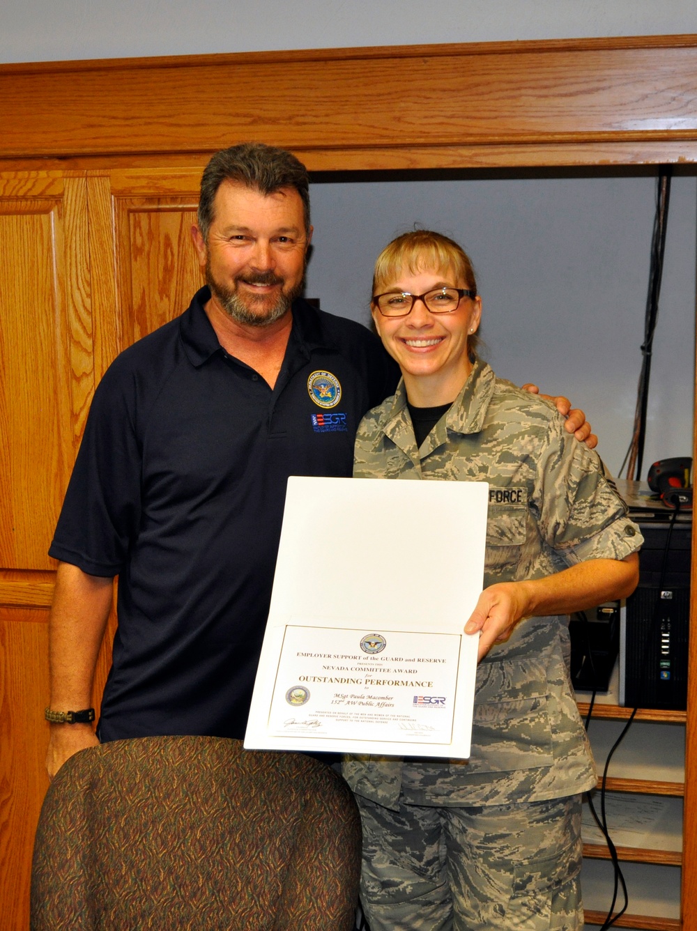 Master Sgt. Paula Macomber receives 'ESGR Outstanding Performance' award for her support during an employer recognition luncheon