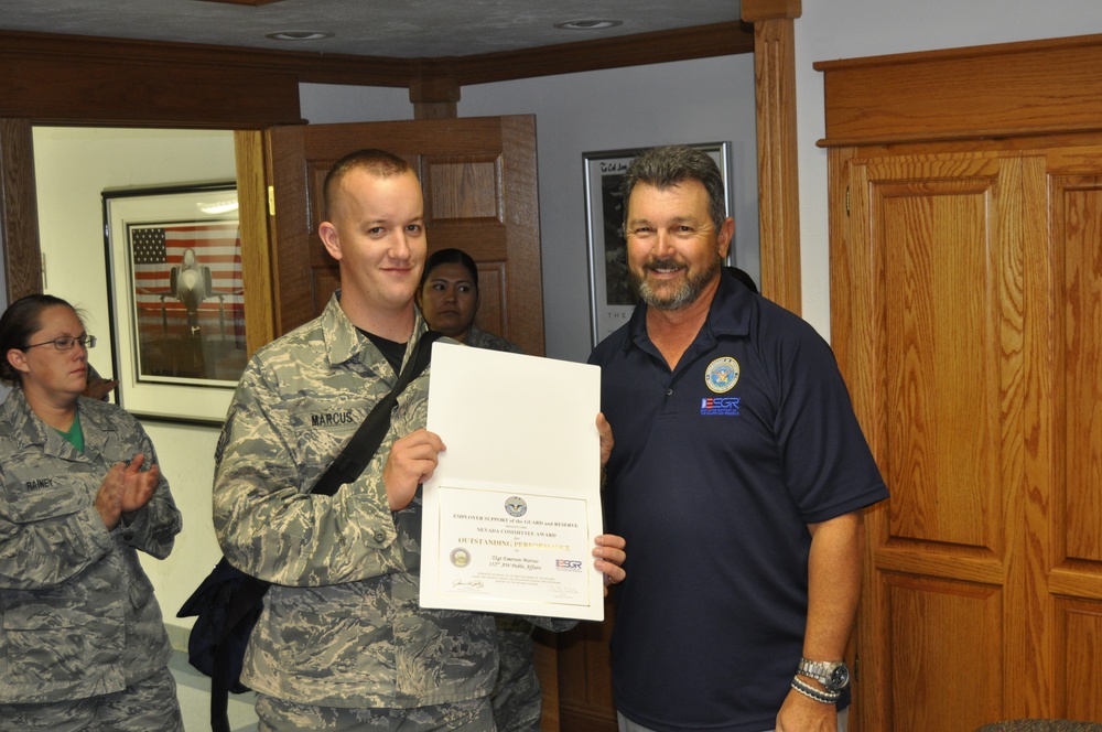 Tech. Sgt. Emerson Marcus receives 'ESGR Outstanding Performance' award for his support during an employer recognition luncheon