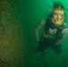 Navy divers inspect a pier in Bahrain
