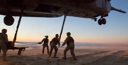 Marines with the 26th MEU perform lift at sunset on the beach