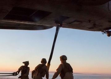 Marines with the 26th MEU perform lift at sunset on the beach