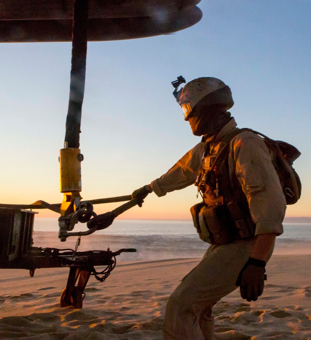 Marines with the 26th MEU perform lift at sunset on the beach