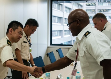 A firm handshake across the table