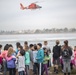 A Coast Guard Air Station San Francisco helicopter aircrew performs a demonstration for elementary school students