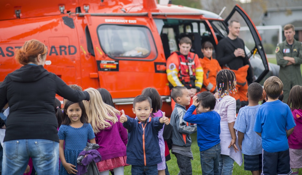 A student gives two thumbs up for the Coast Guard