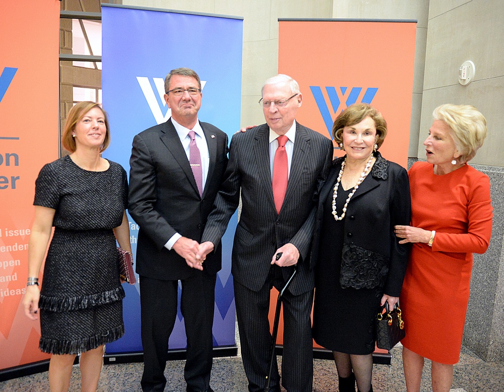 Secretary of defense takes photos with guests before receiving the Woodrow Wilson Award for Public Service