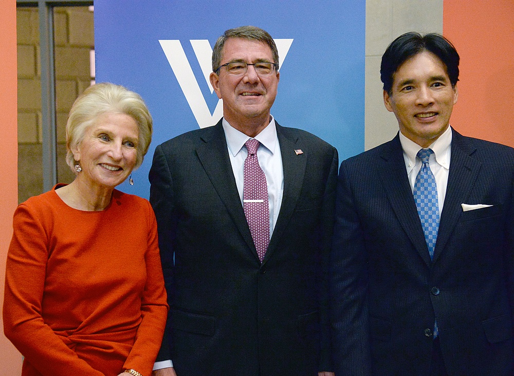 Secretary of defense takes photos with guests before receiving the Woodrow Wilson Award for Public Service