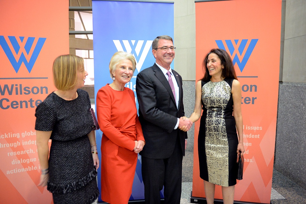 Secretary of defense takes photos with guests before receiving the Woodrow Wilson Award for Public Service