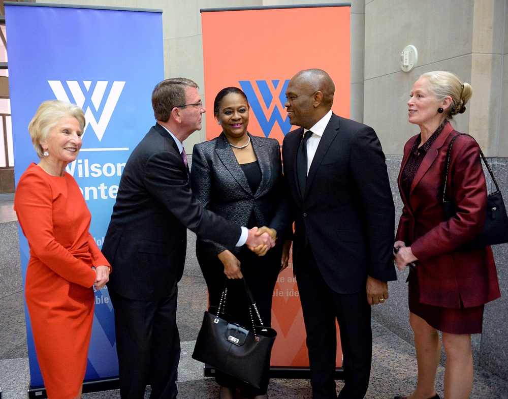 Secretary of defense takes photos with guests before receiving the Woodrow Wilson Award for Public Service