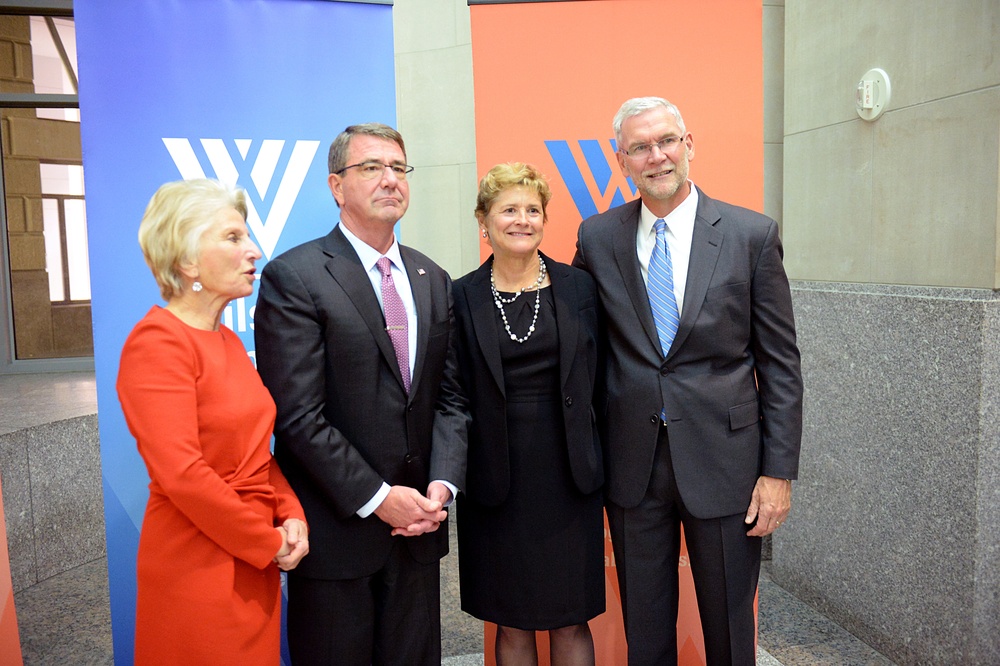 Secretary of defense takes photos with guests before receiving the Woodrow Wilson Award for Public Service