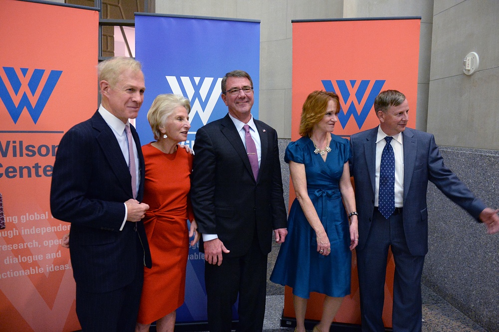 Secretary of defense takes photos with guests before receiving the Woodrow Wilson Award for Public Service