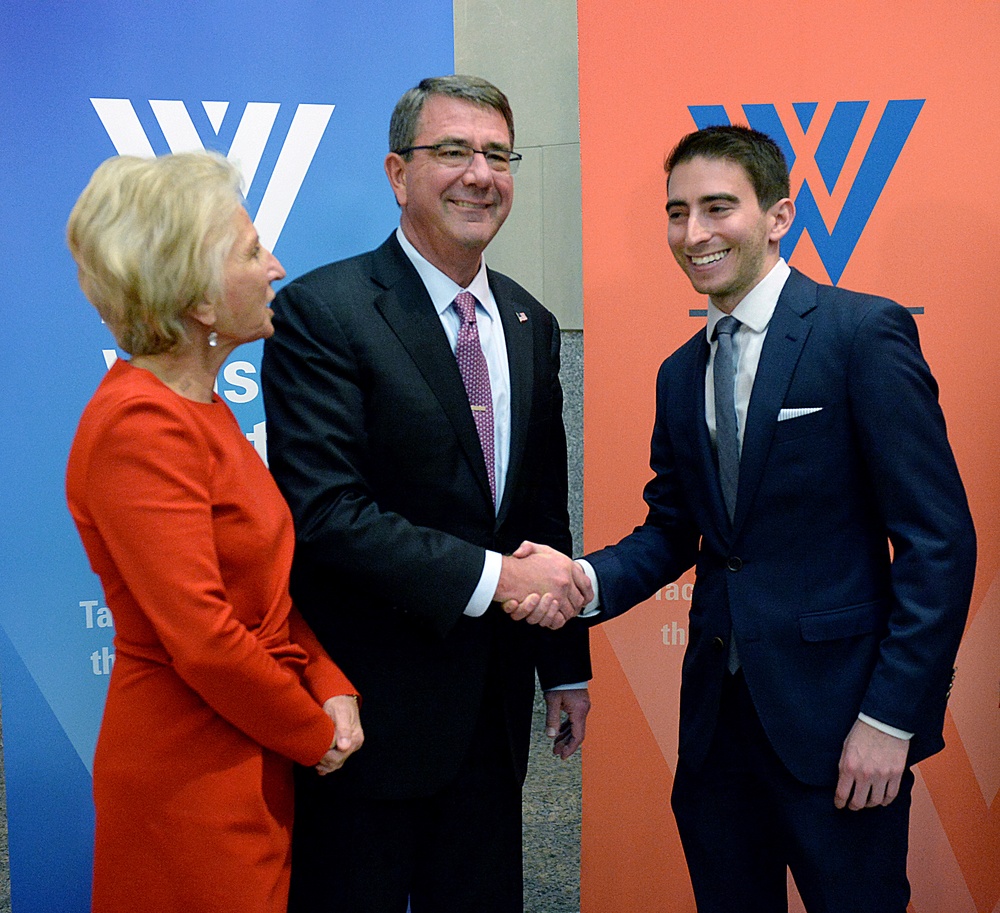 Secretary of defense takes photos with guests before receiving the Woodrow Wilson Award for Public Service