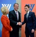 Secretary of defense takes photos with guests before receiving the Woodrow Wilson Award for Public Service