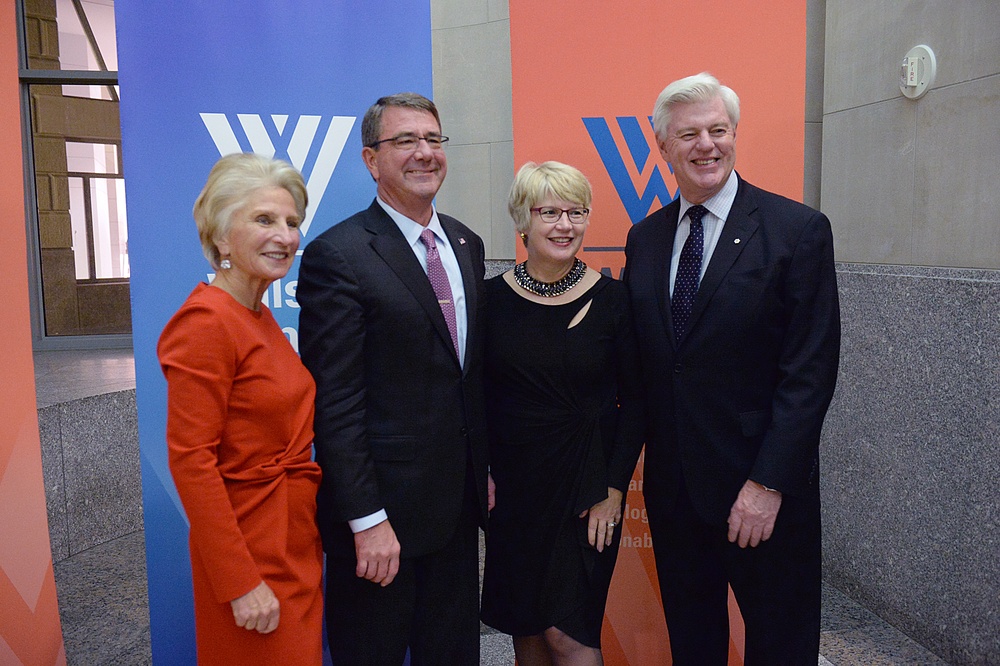 Secretary of defense takes photos with guests before receiving the Woodrow Wilson Award for Public Service