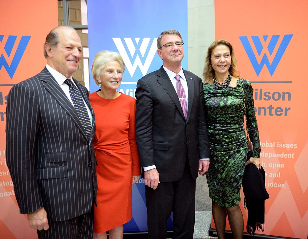 Secretary of defense takes photos with guests before receiving the Woodrow Wilson Award for Public Service