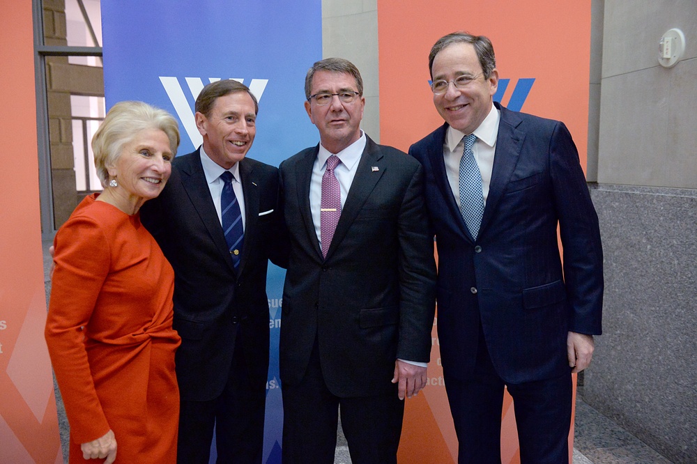 Secretary of defense takes photos with guests before receiving the Woodrow Wilson Award for Public Service