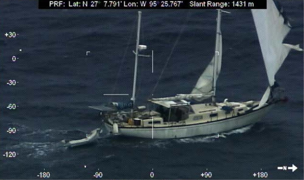 Disabled sailboat crew waits for help