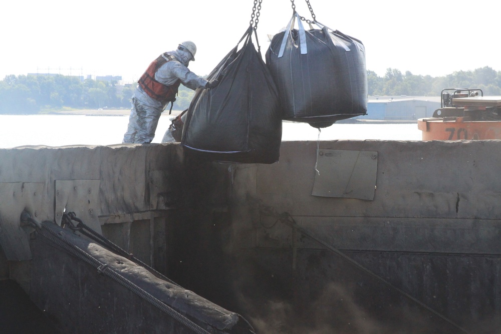 Adding activated carbon to dredged sediment