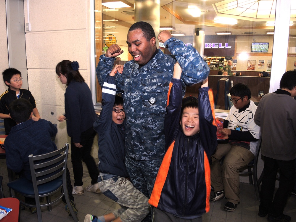 NAF Misawa Sailors give Japanese elementary school students a tour of Misawa Air Base