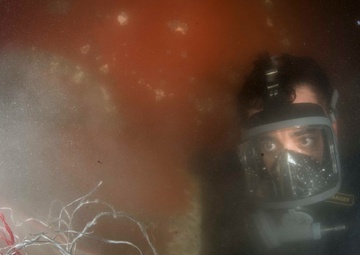 Navy diver removes tangled line from ship in Bahrain