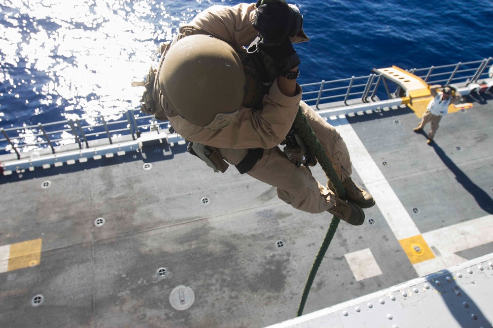 US Marines practice rappelling at sea