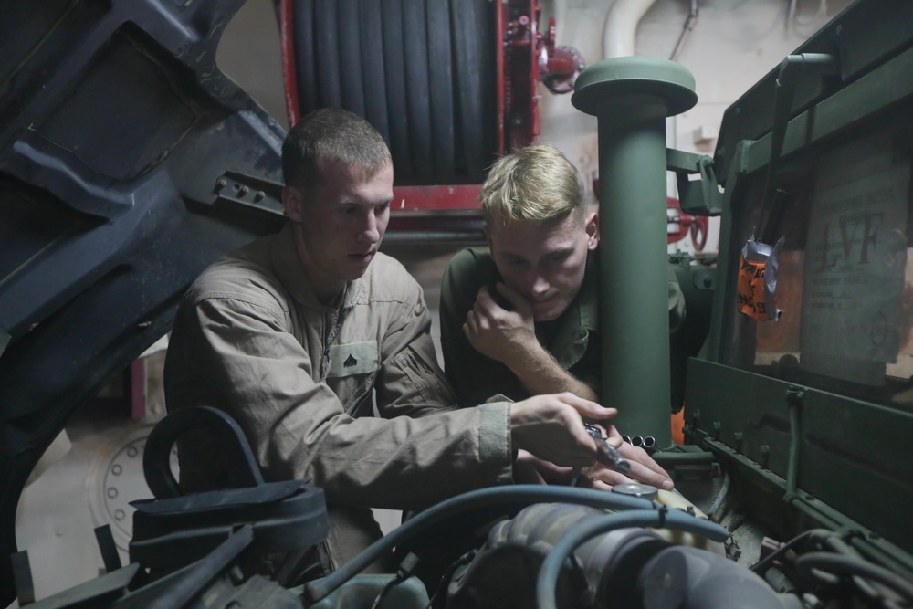 US Marines maintain vehicles at sea