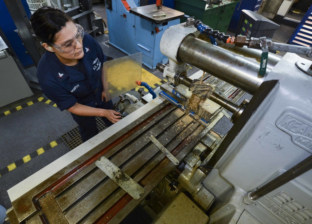 Machinery repairman performs maintenance for Nimitz NAMTS Program
