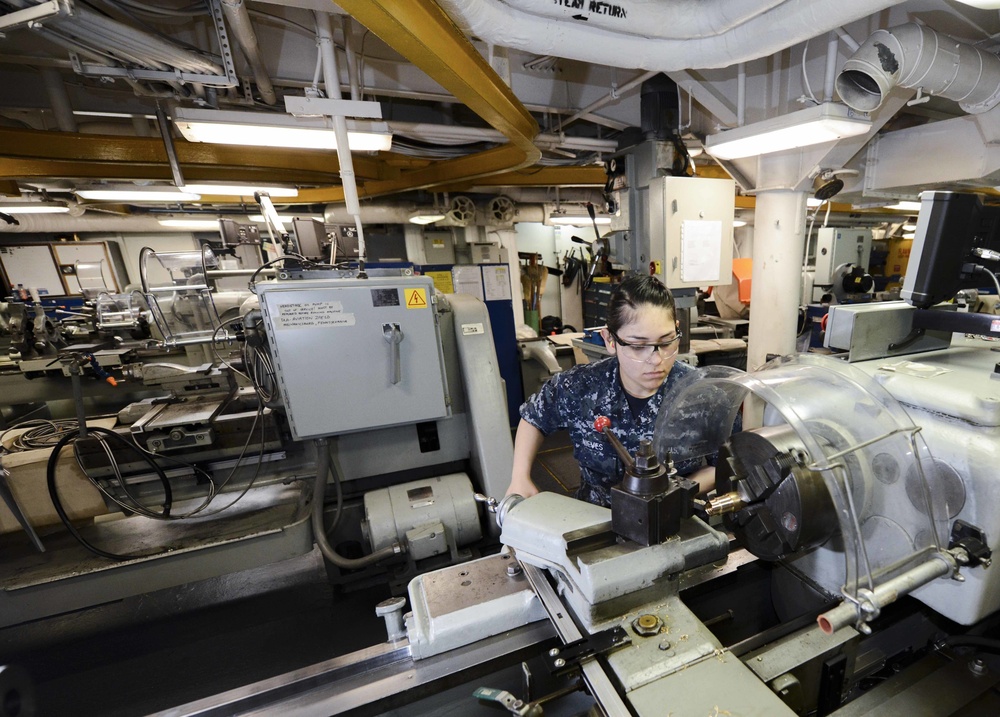 Machinery repairman performs maintenance for Nimitz NAMTS Program