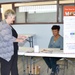 Cheri Magorno, multimedia specialist, asks questions of the Mail Handlers Benefits Program representative, Kitty McNeil, at the Benefits Fair held aboard Marine Corps Logistics Base Barstow, Calif., Oct. 28
