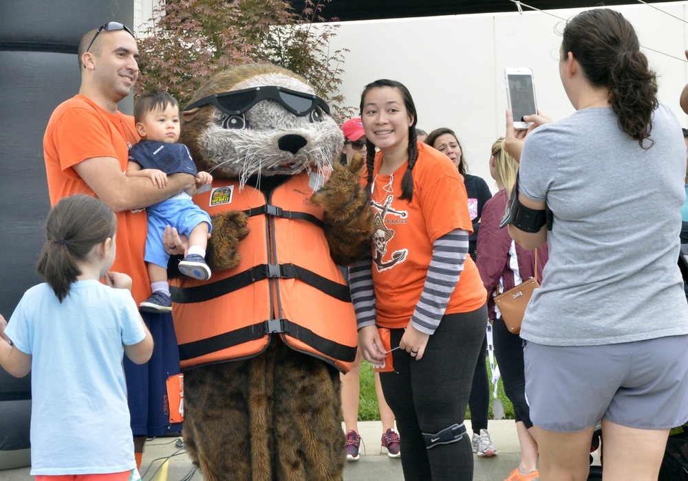 Family poses with Sammy the Sea Otter