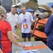 Rear Adm. Steven P. Metruck and Master Chief Petty Officer Mark Pearson talk with Sammy the Sea Otter