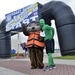 Sammy the Sea Otter and Green Man pose during Coast Guard Day 5k