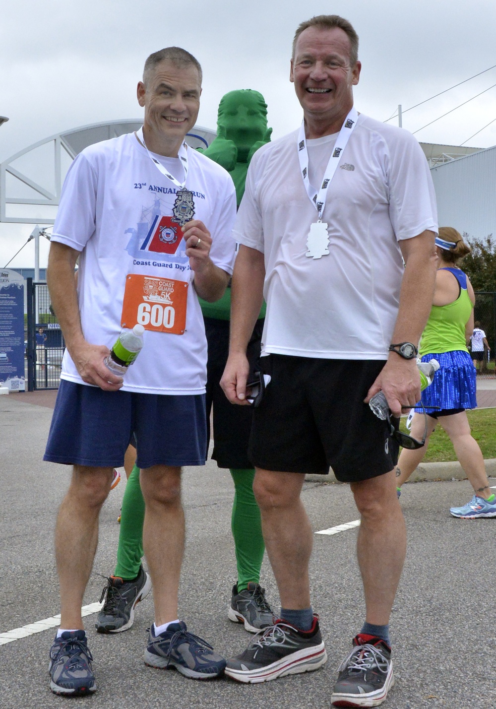 Rear Adm. Steven P. Metruck and Master Chief Petty Officer Mark Pearson pose after Coast Guard Day 5K