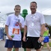 Rear Adm. Steven P. Metruck and Master Chief Petty Officer Mark Pearson pose after Coast Guard Day 5K