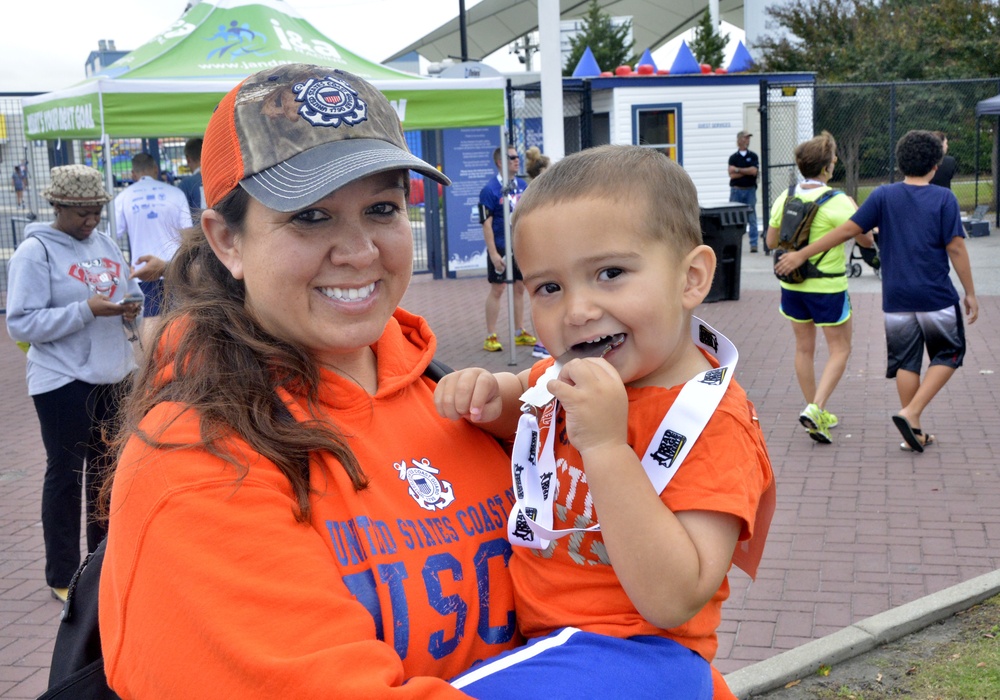 Petty Officer 1st Class Thao Barnes and son Gavinh pose after race