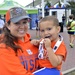 Petty Officer 1st Class Thao Barnes and son Gavinh pose after race