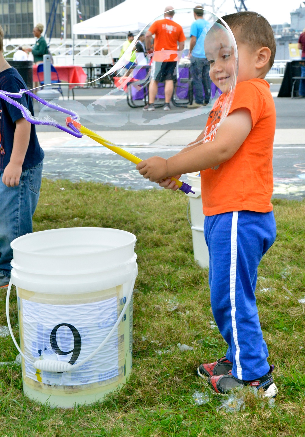 Coast Guard child plays with bubbles at Coast Guard Day 5k