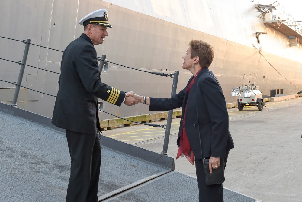 USS New York CO Kenneth Coleman is greeted portside by Dr. Loree Sutton after their arrival in New York.