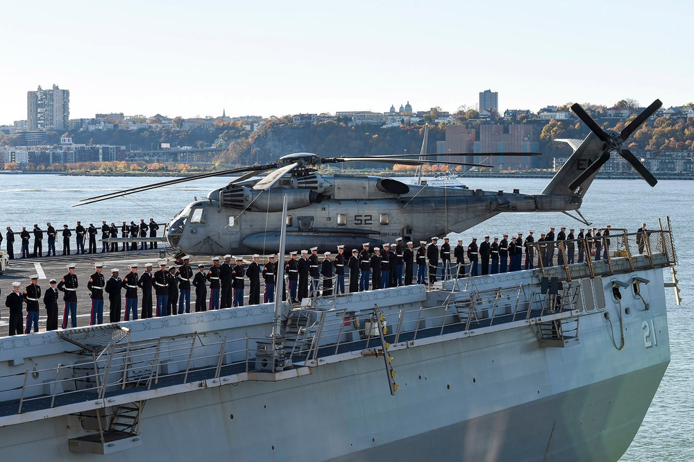 Sailors and Marines man the rails as the amphibious landing dock ship USS New York (LPD 21) pulls into port