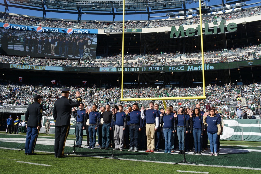 Future service members recite the oath of enlistment in front of fans at MetLife Stadium