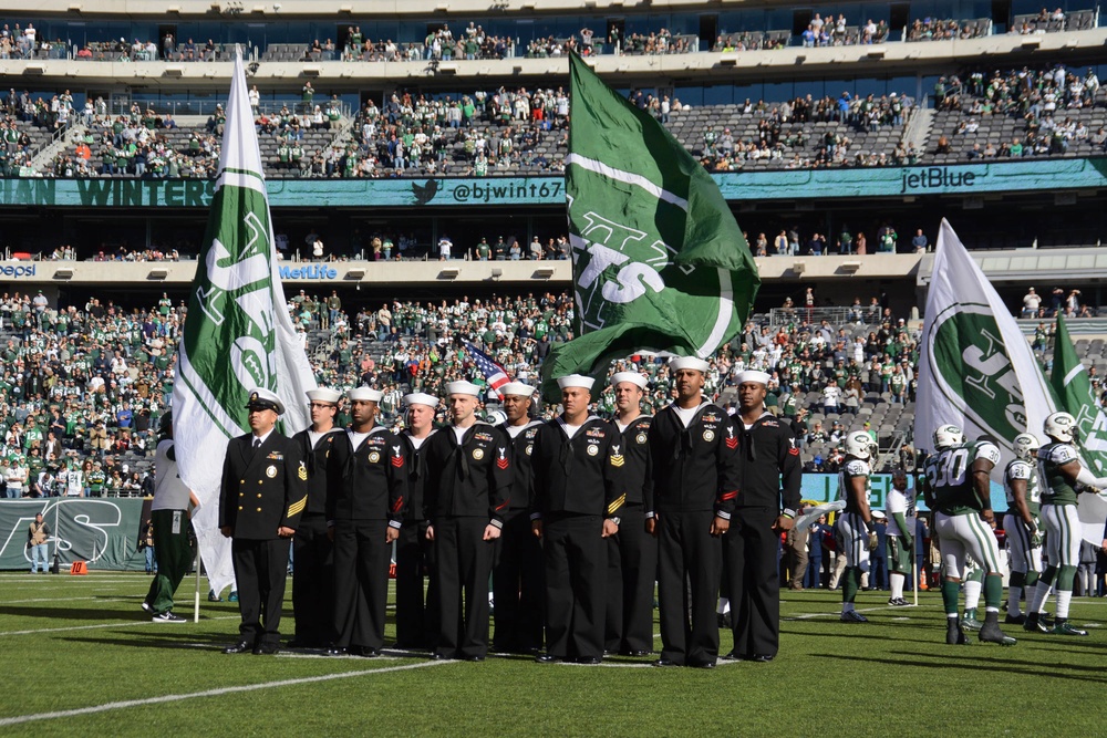 Sailors assigned to Navy Recruiting District New York stand in formation at MetLife Stadium during a Veterans Day military appreciation game