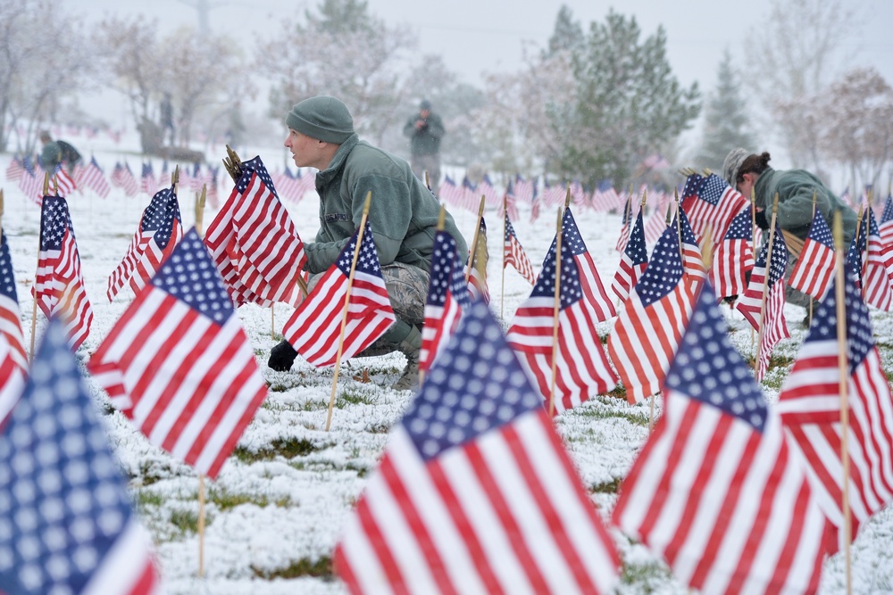 Airmen place flags, honor Veterans Day