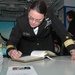 Rear Adm. Cynthia M. Thebaud, commander Expeditionary Strike Group 2, signs the guest book at the National Sept. 11 Memorial and Museum