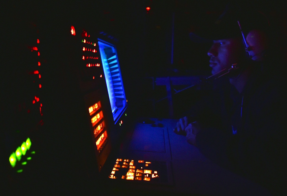 USS Stethem (DDG 63) sailor stands bridge watch at night