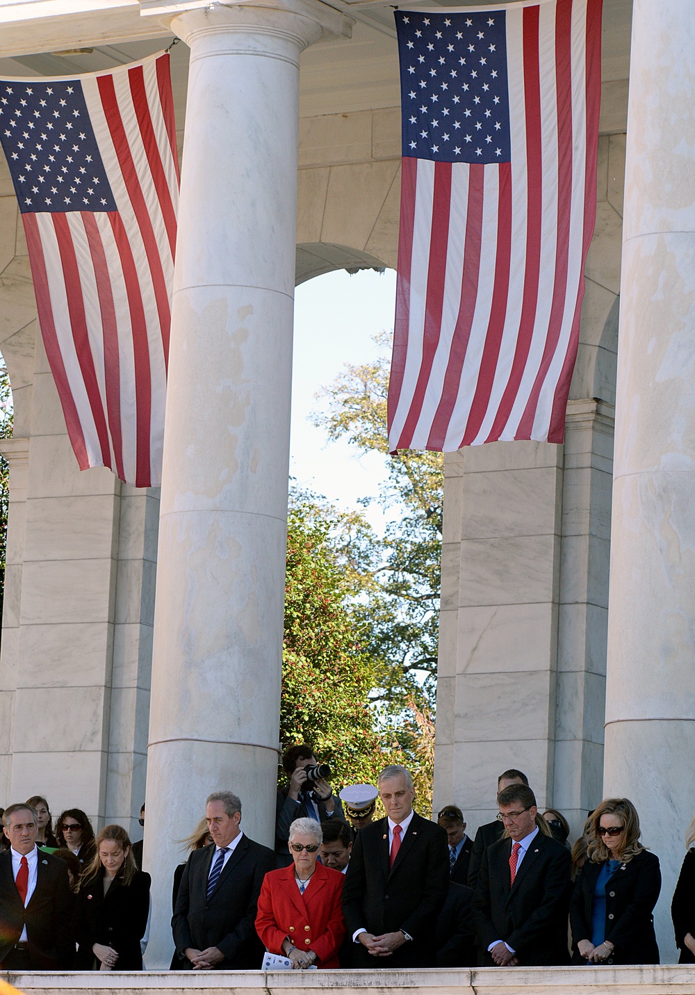 Secretary of defense bows his head during a prayer at the 62nd annual national Veterans Day observance at Arlington National Cemetery