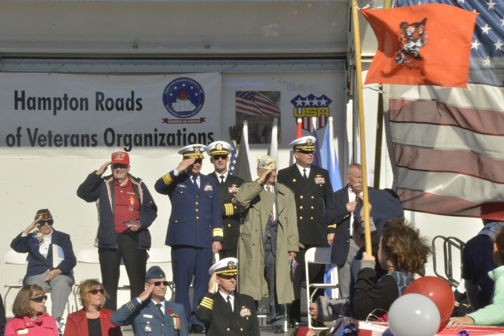Rear Adm. Steven P. Metruck salutes with honored veterans